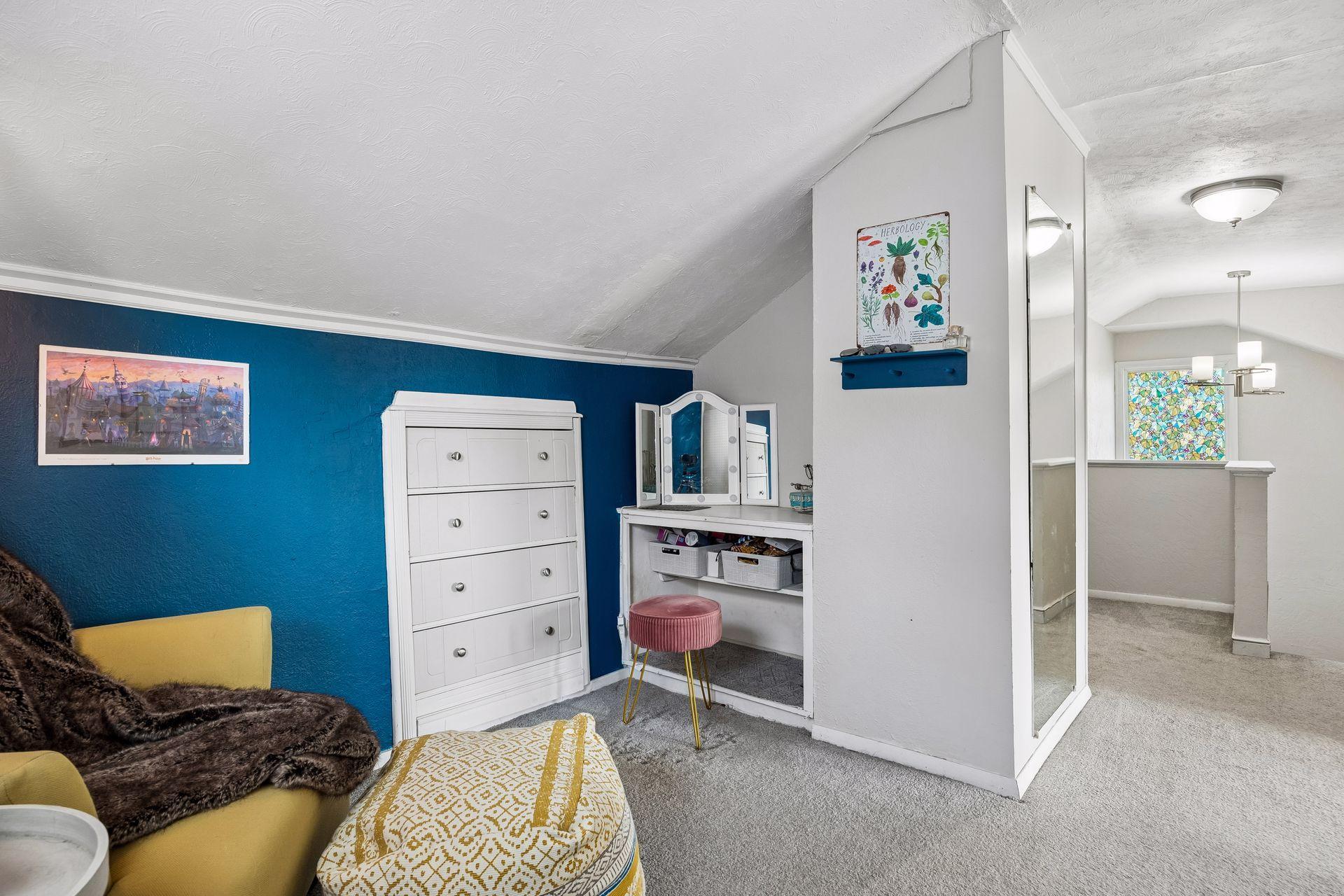 Classic built-ins, including a vanity and chest of drawers, create a charming dressing area that further reflects the craftsmanship for this era.
