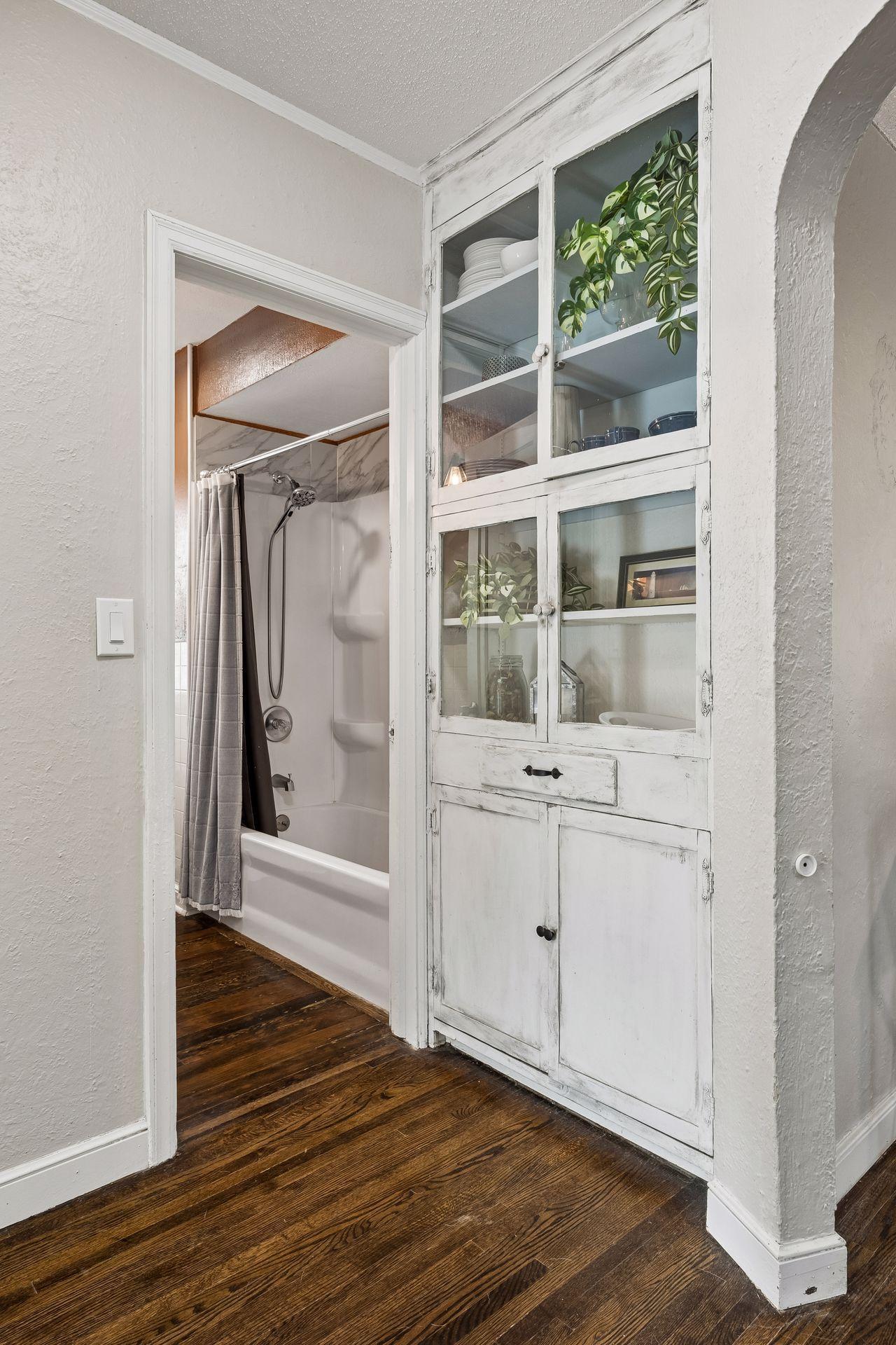 A timeless touch of craftsmanship. This original built-in china cabinet offers elegant display space, practical storage, and a beautiful reminder of the home's 1940s character.