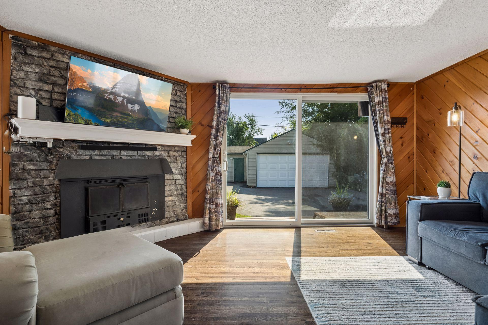 The perfect extension of your living space. This inviting main-floor family room is filled with natural light and opens directly to the new deck, fully fenced backyard, and detached two-car garage, creating an ideal space for everyday living.