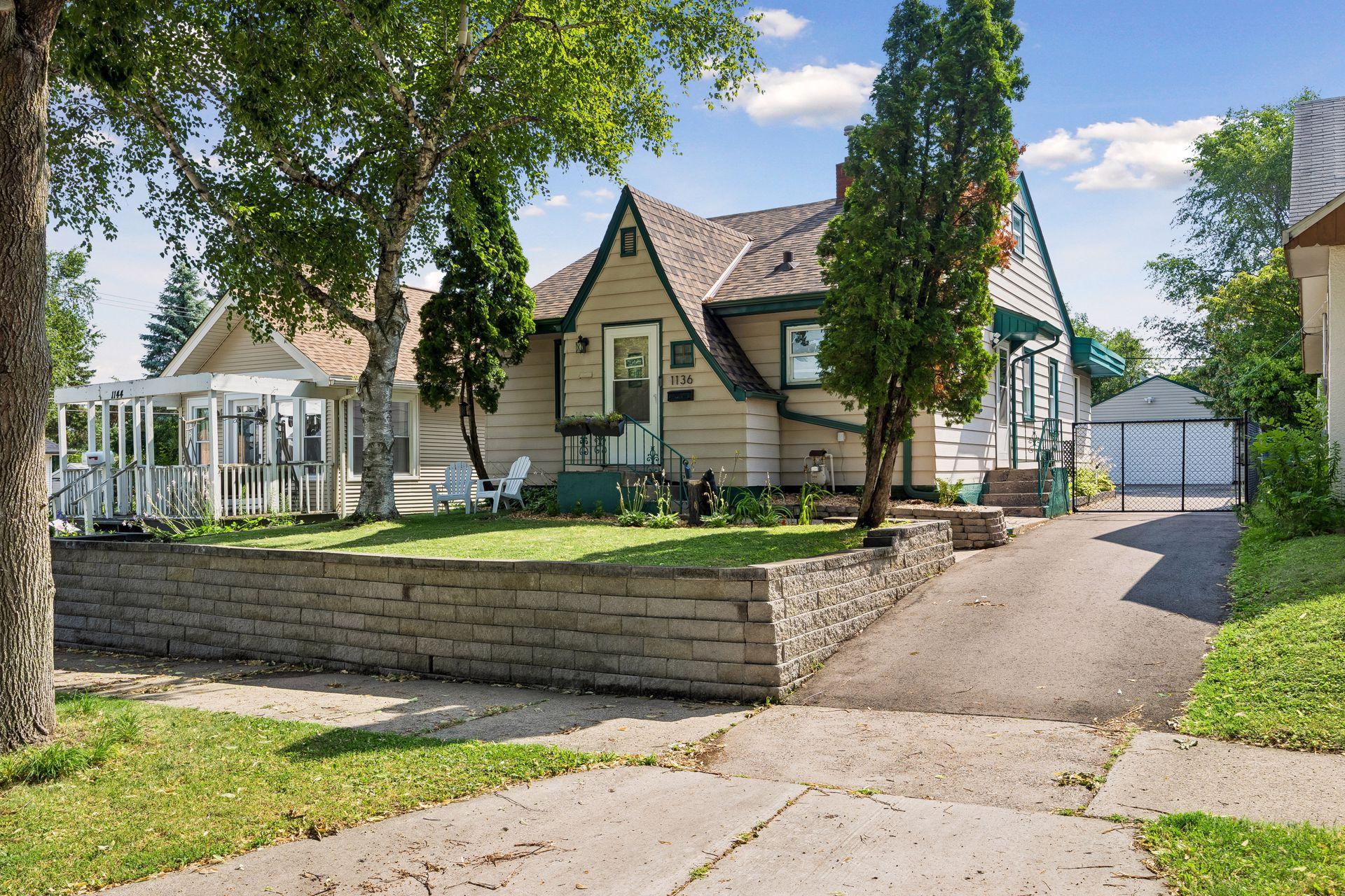Storybook charm begins at the curb! This classic 1941 home welcomes you with mature trees, timeless architecture, a new driveway, rebuilt retaining wall, and a gated entrance leading to the detached two-car garage.