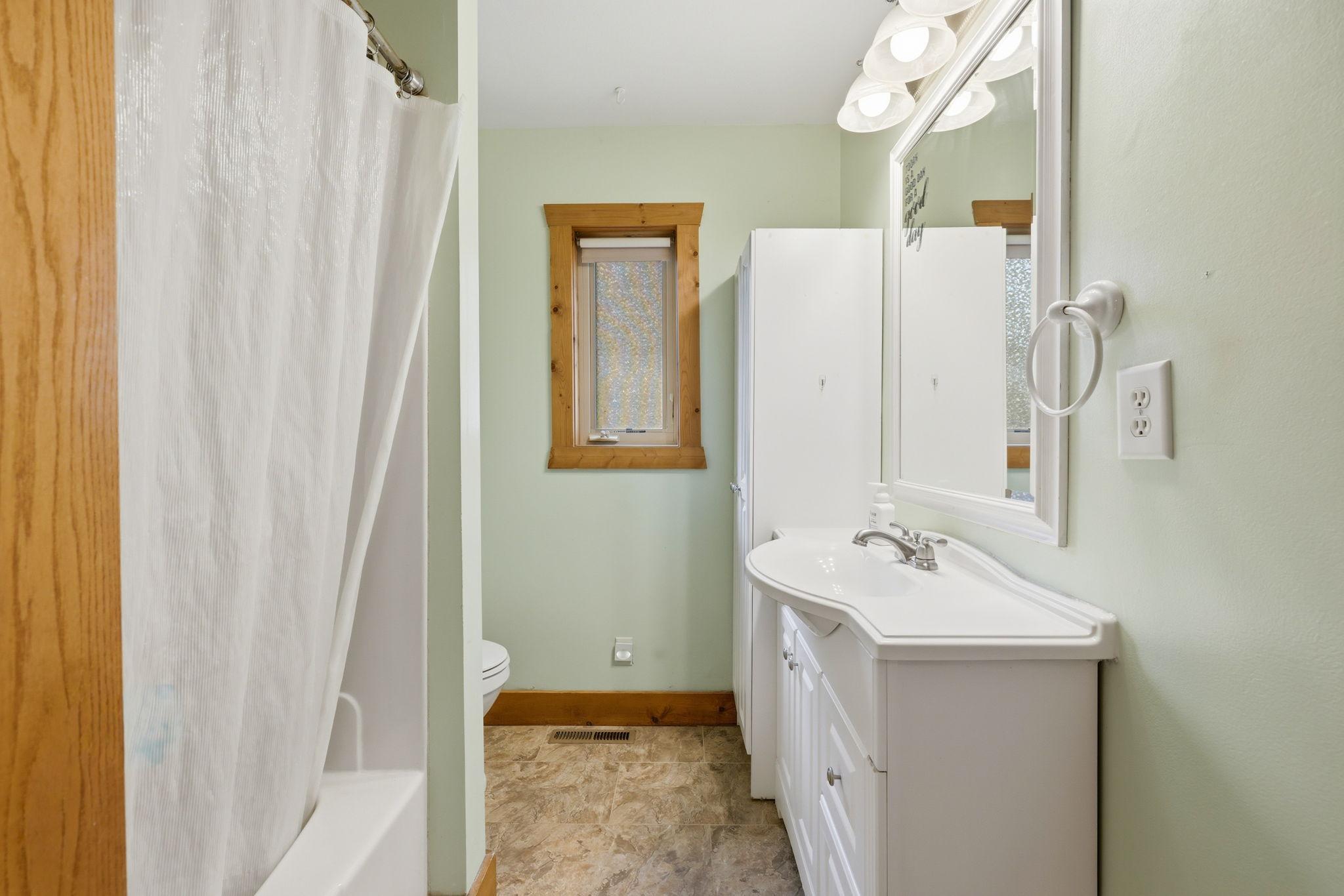 Full sized bathroom off the mud room and kitchen