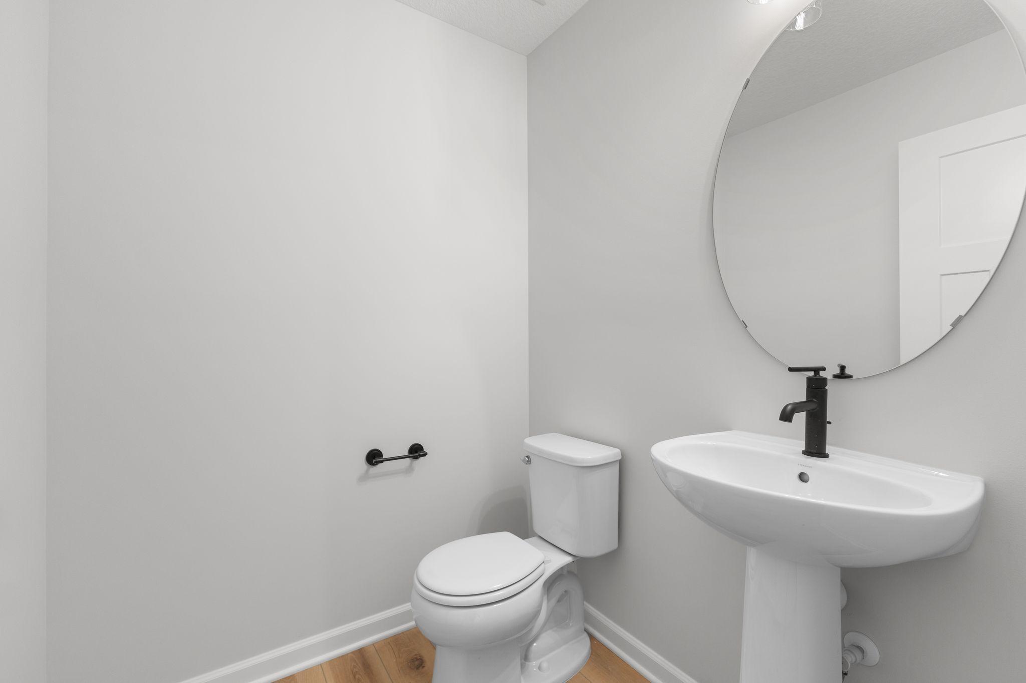 Main level powder bath. Photo used for layout purposes. Finishes may be different.
