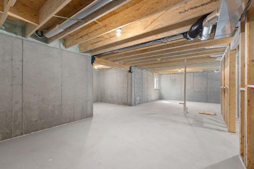 Unfinished lower level with egress window.