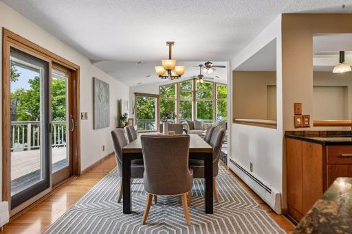 Dining room table sits just off the sliding door out to the deck with ample space for dinner parties