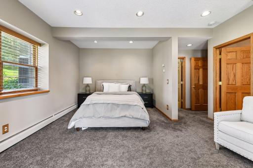 Owners suite in lower level has 9 ft ceilings fireplace and walkout doors to the lake