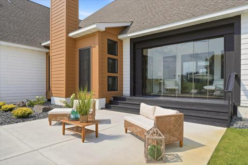 Retractable glass wall to create and indoor-outdoor experience from this sunroom connecting the home to the pool and patio