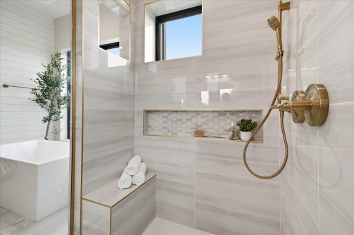 Spa-inspired with separate vanities, soaking tub, and tiled walk-in shower