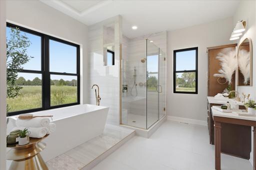 Spa-inspired with separate vanities, soaking tub, and tiled walk-in shower