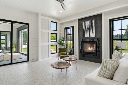 Sun Room/Family Room with gas fireplace and access to patio, pool and private back yard