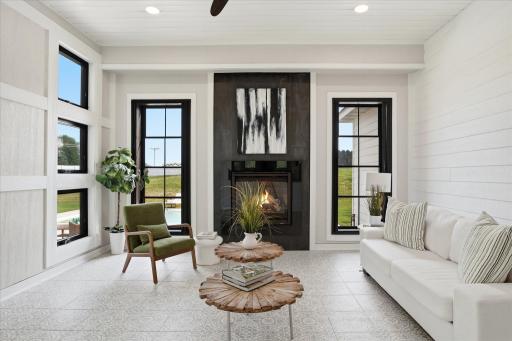 Sun Room/Family Room with gas fireplace and access to patio, pool and private back yard