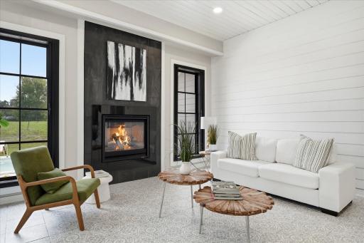 Sun Room/Family Room with gas fireplace and access to patio, pool and private back yard