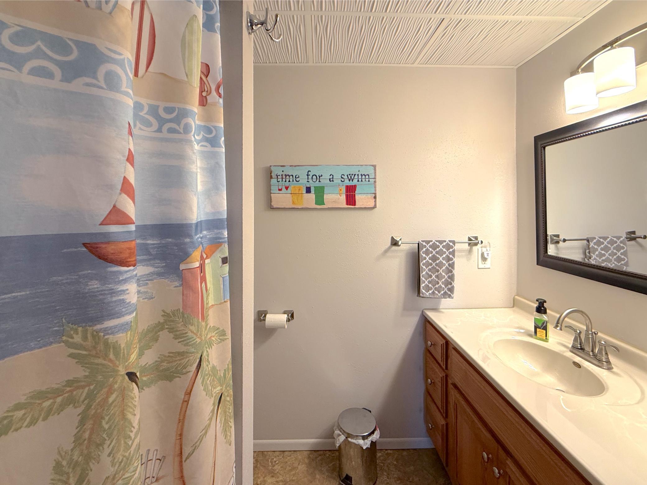 This clean, functional full bathroom offers a large vanity, extra storage cabinetry, and a tub/shower combination to accommodate everyday living.
