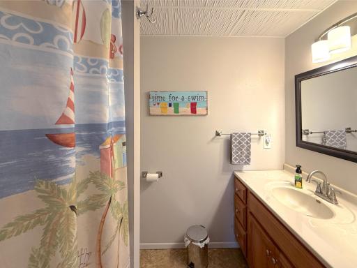 This clean, functional full bathroom offers a large vanity, extra storage cabinetry, and a tub/shower combination to accommodate everyday living.
