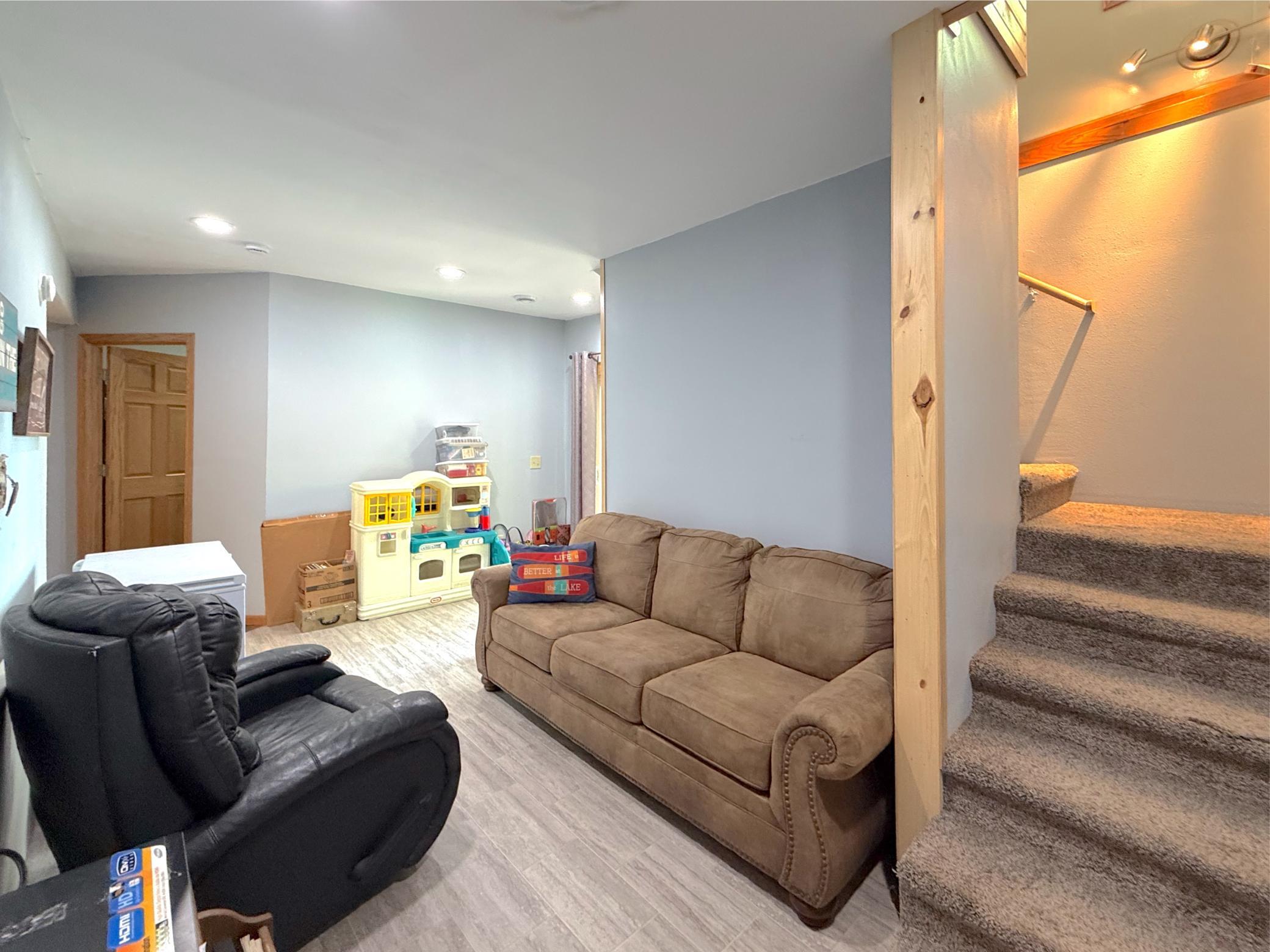 This versatile finished basement living area provides endless possibilities for a media room, playroom, or comfortable guest retreat.