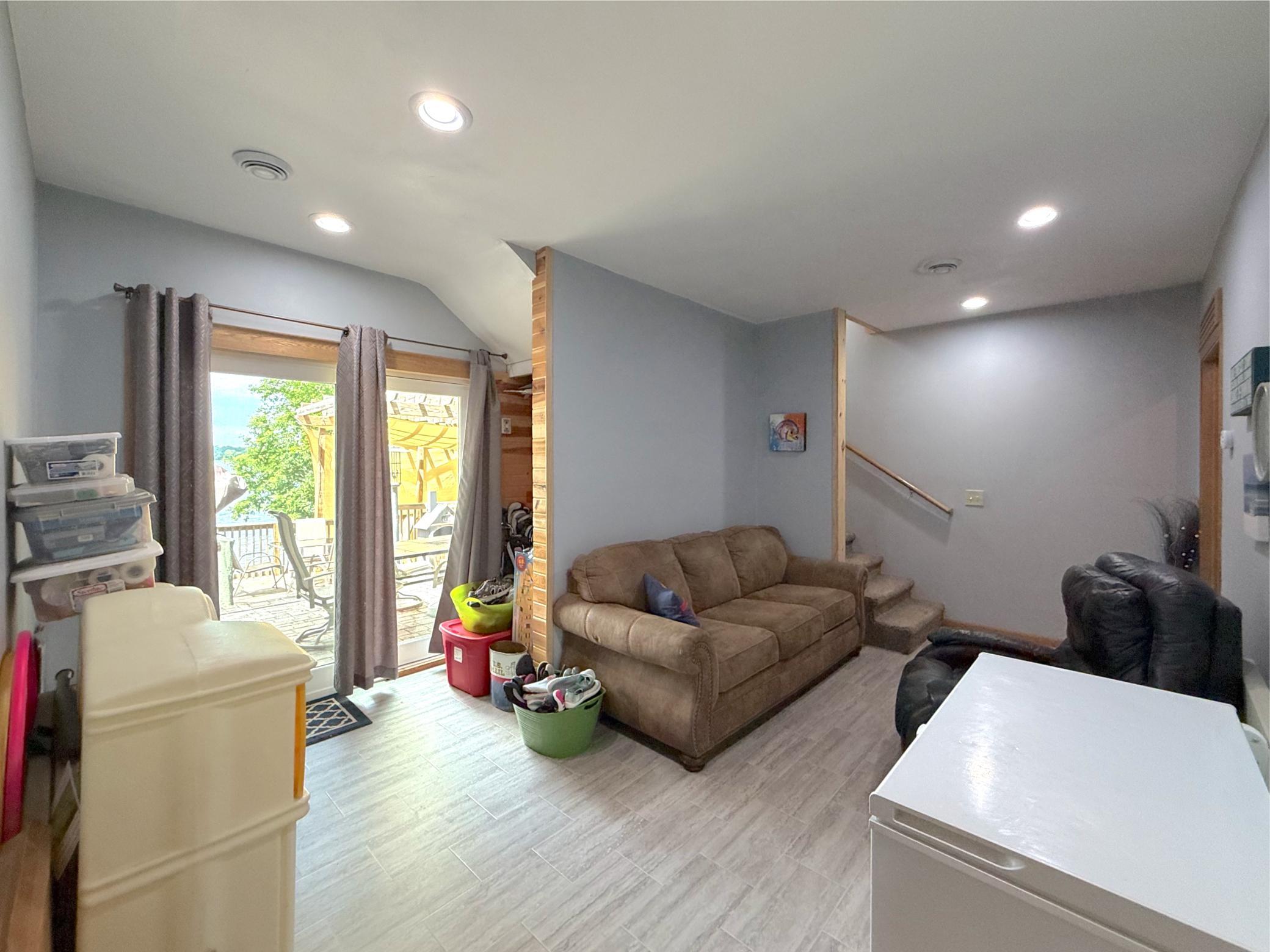 The expansive lower-level family room adds valuable living space with durable flooring and plenty of room for entertaining or everyday enjoyment.