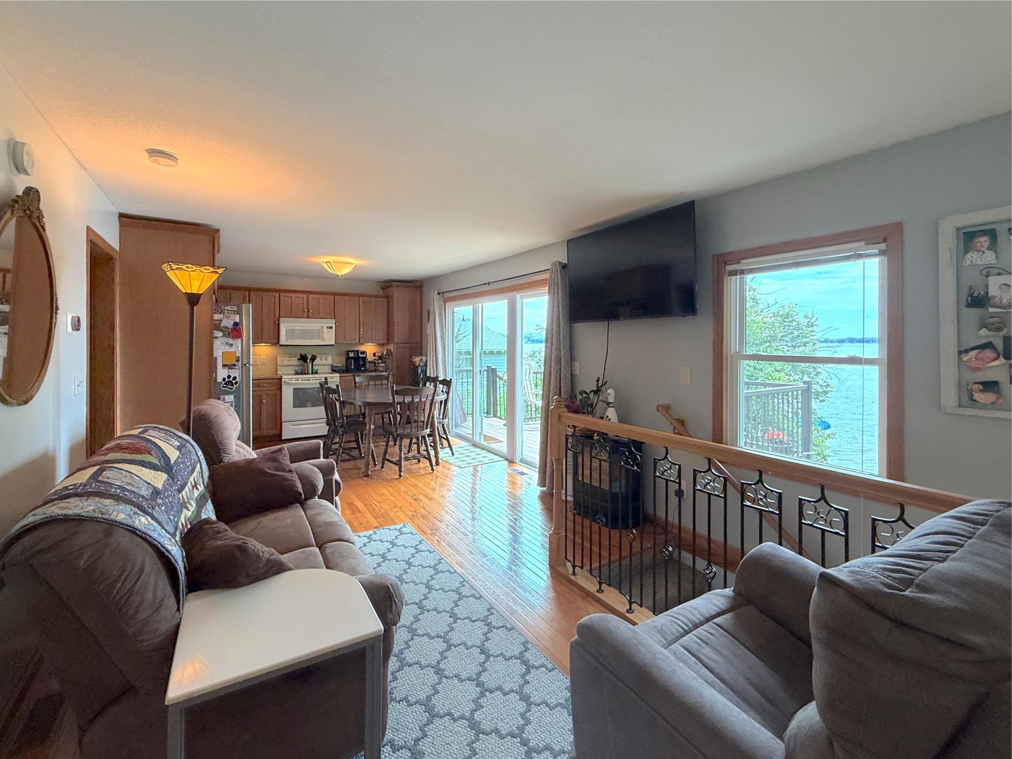 The open-concept living, dining, and kitchen area is filled with natural light and flows seamlessly to the deck, creating an ideal space for everyday living and entertaining.