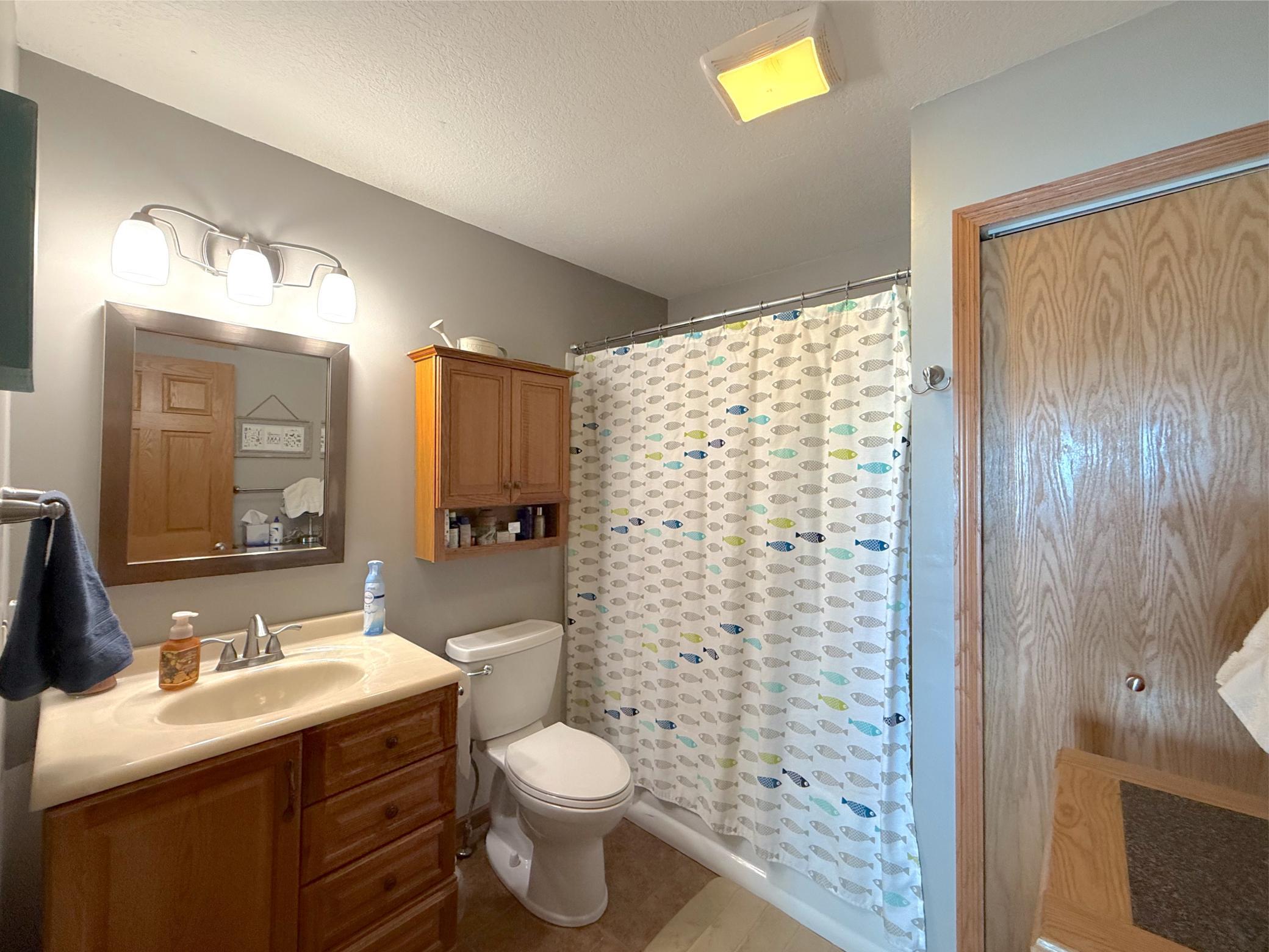 The full bathroom features a spacious vanity with ample storage and a convenient tub/shower combination, offering both style and functionality.