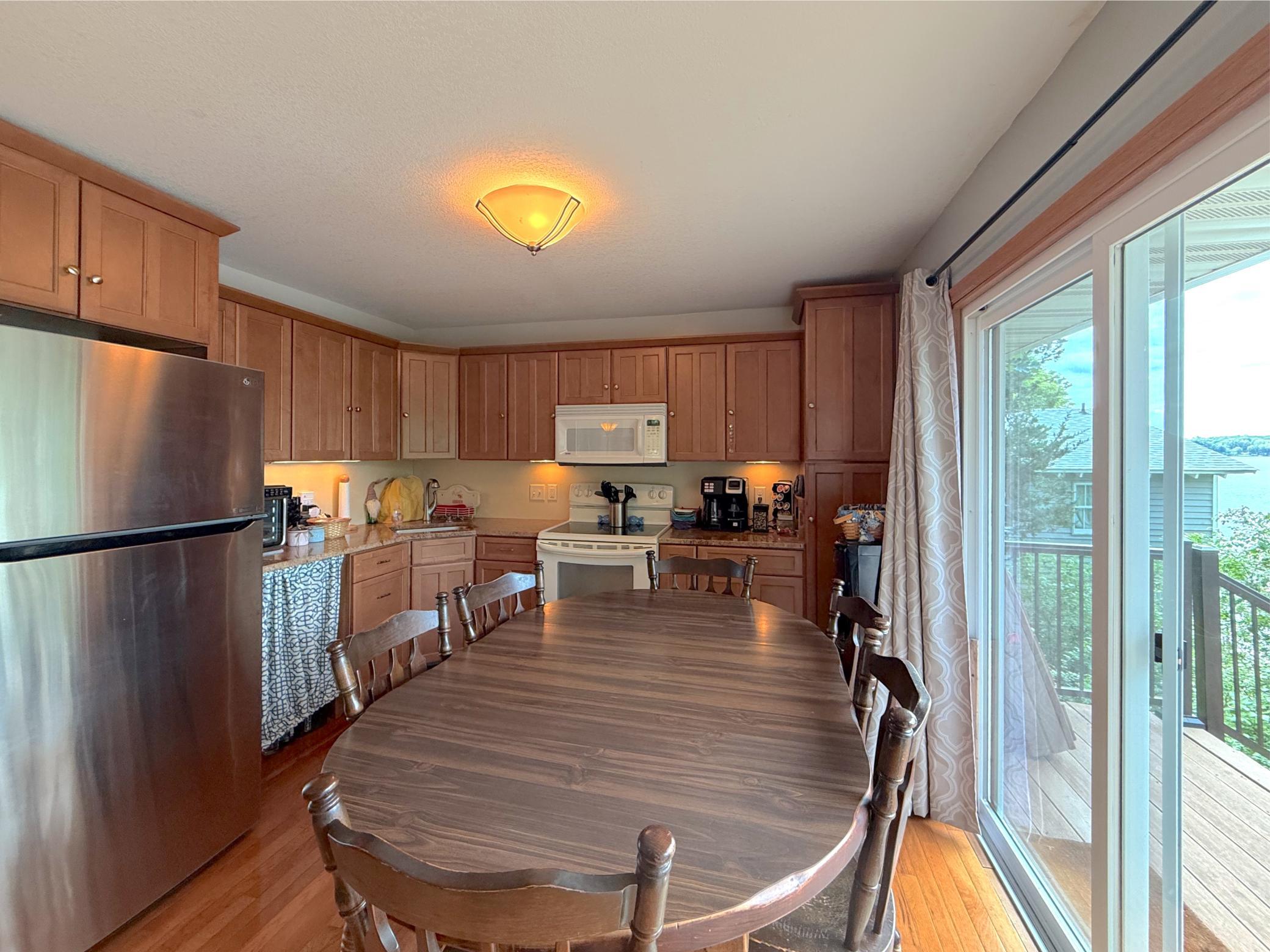 Enjoy gathering in the bright dining area, where sliding glass doors open to the deck and invite in natural light and scenic views.