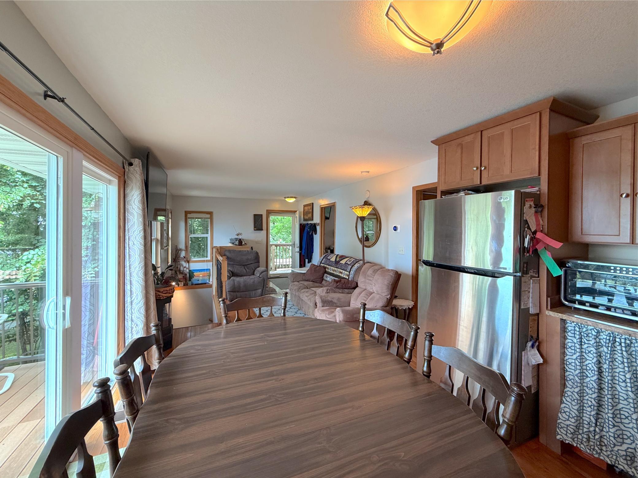 The spacious eat-in kitchen offers abundant cabinetry, generous prep space, and direct access to the deck, making indoor-outdoor entertaining a breeze.