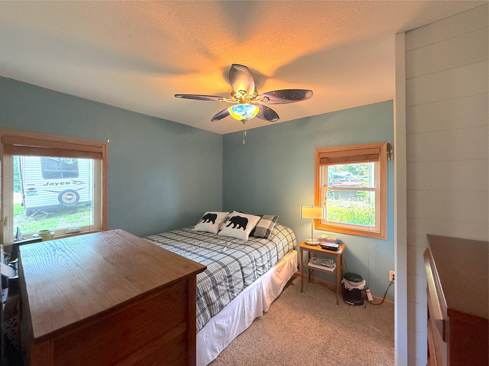 Enjoy the comfort of a secondary bedroom complete with natural light, ceiling fan, neutral finishes, and a relaxing ambiance.