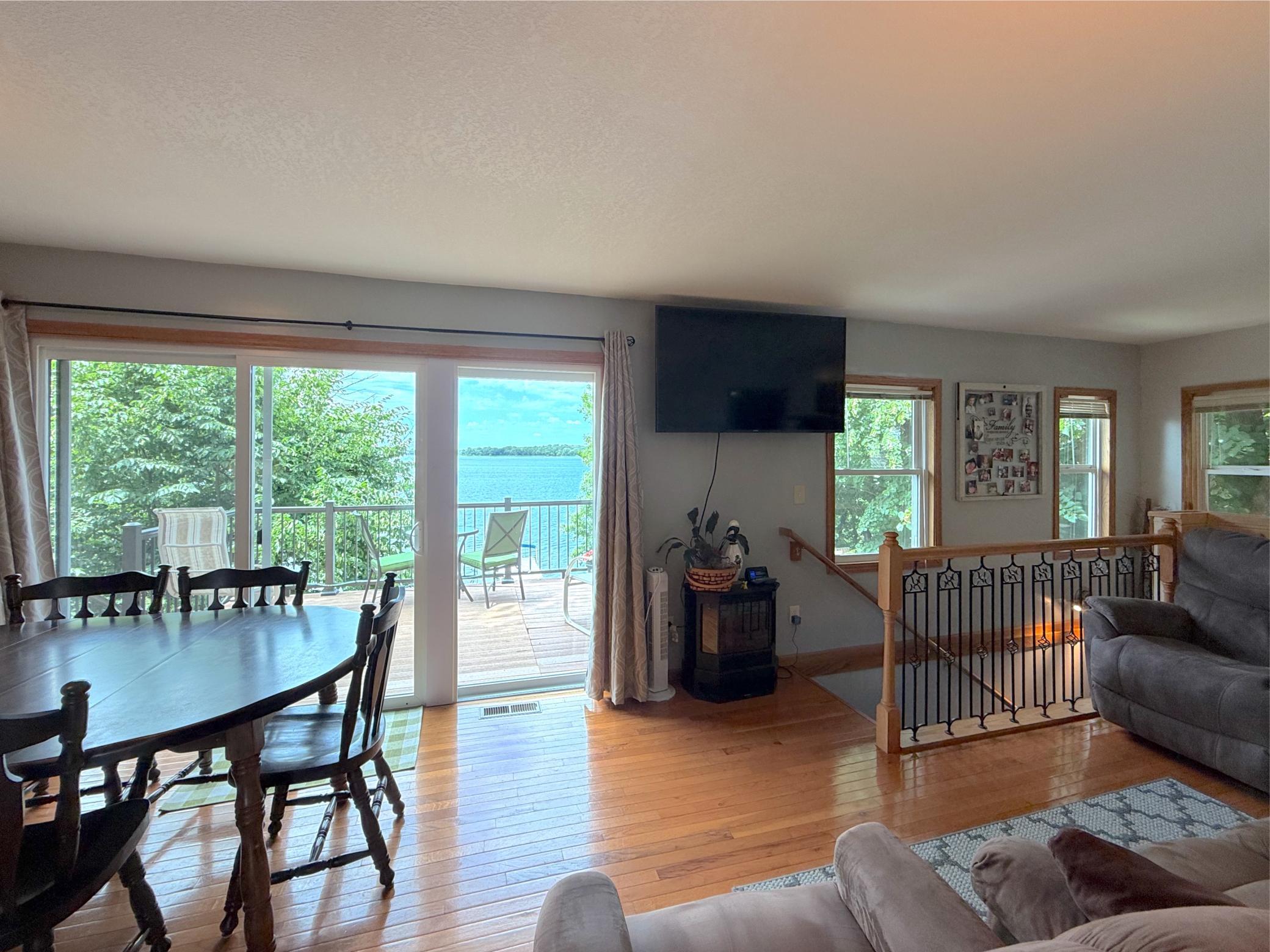 Hardwood floors and large windows create a welcoming living space that seamlessly connects to the kitchen and dining area.