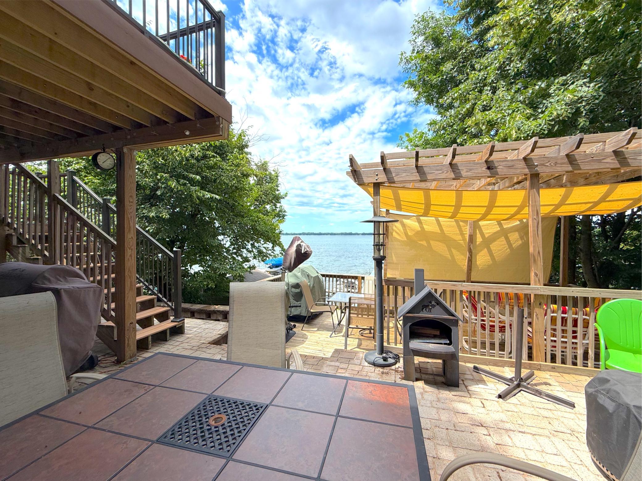 This impressive lakeside deck is perfectly positioned to capture peaceful water views while providing abundant space for outdoor enjoyment.