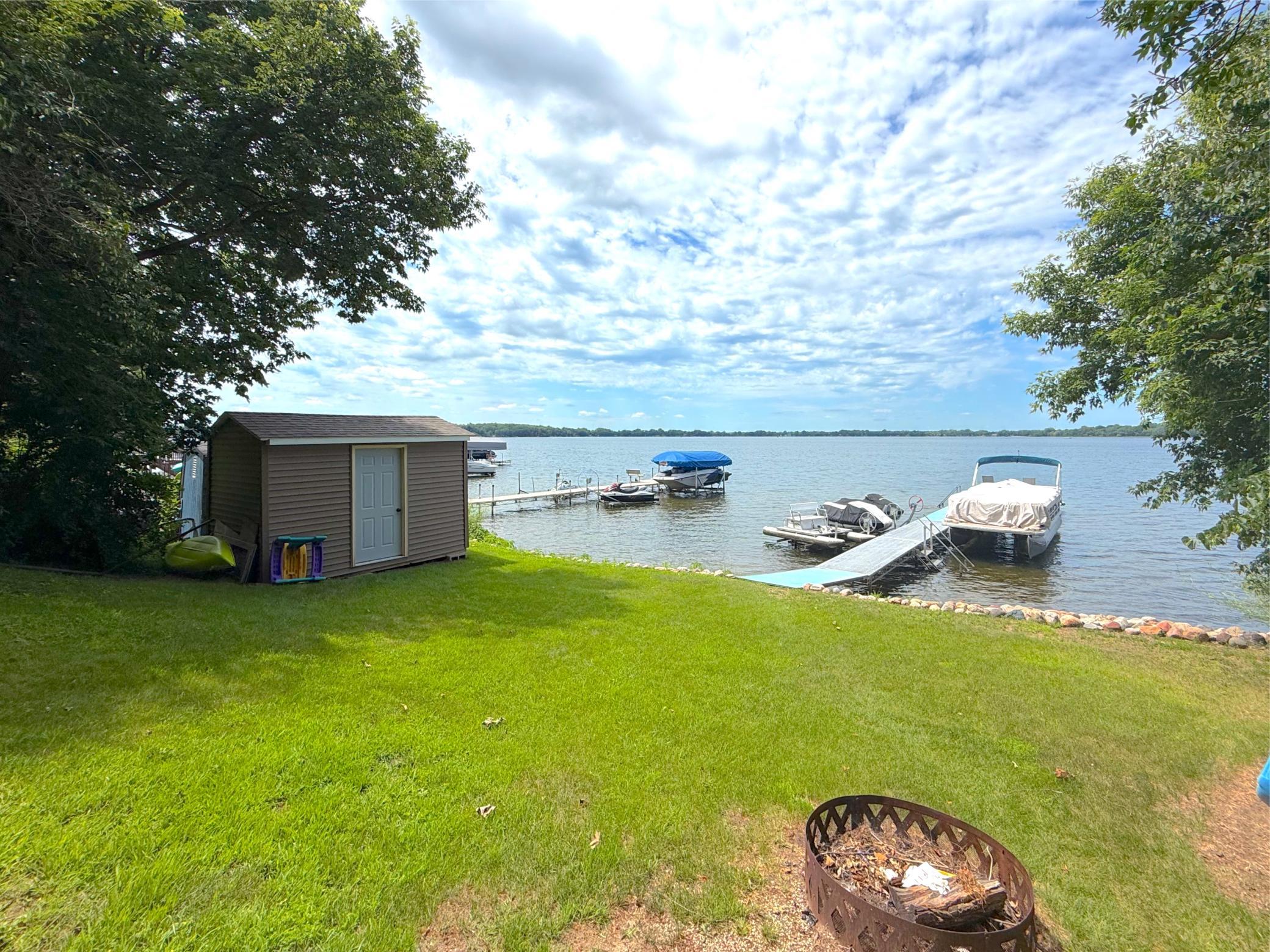 The level lakeside yard offers plenty of space for outdoor games, relaxing by the fire pit, and effortless access to your private dock on Lake Francis.