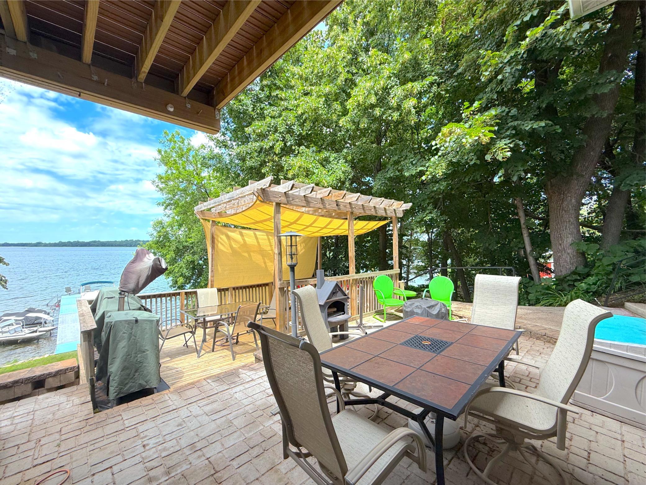 The expansive lakeside deck offers the perfect setting to entertain, relax, and soak in beautiful waterfront views with the perfect amount of sun and shade!