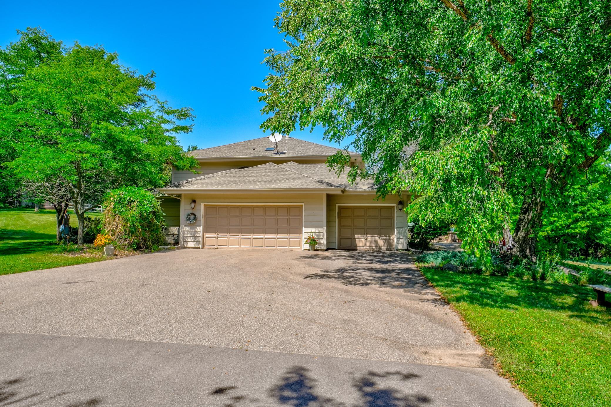 Completing this remarkable property is an attached three-stall garage with convenient stairway access to the lower level and a new blacktop driveway