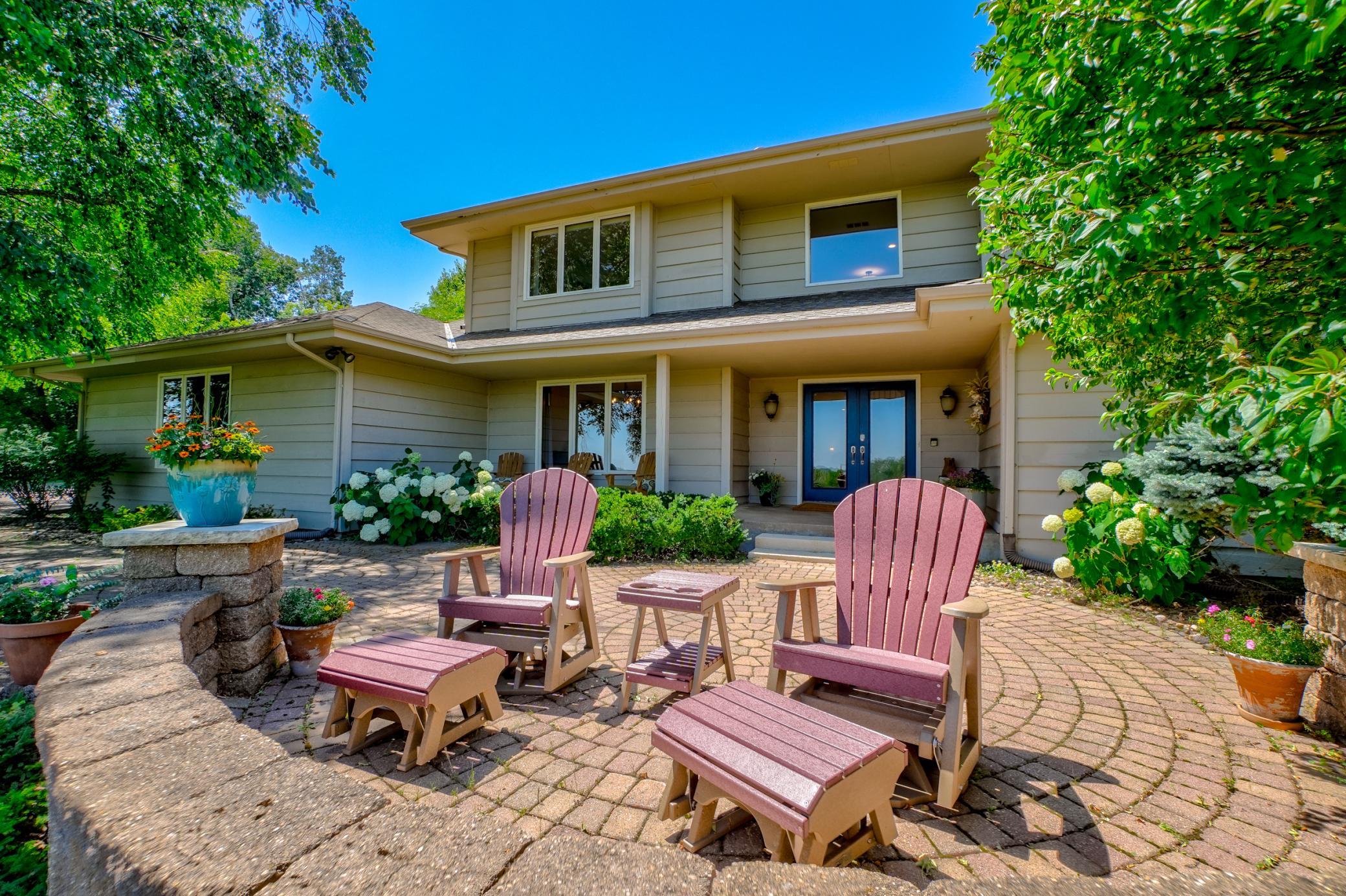The inviting paver patio offers the perfect place to relax and soak in the stunning St. Croix River bluff views