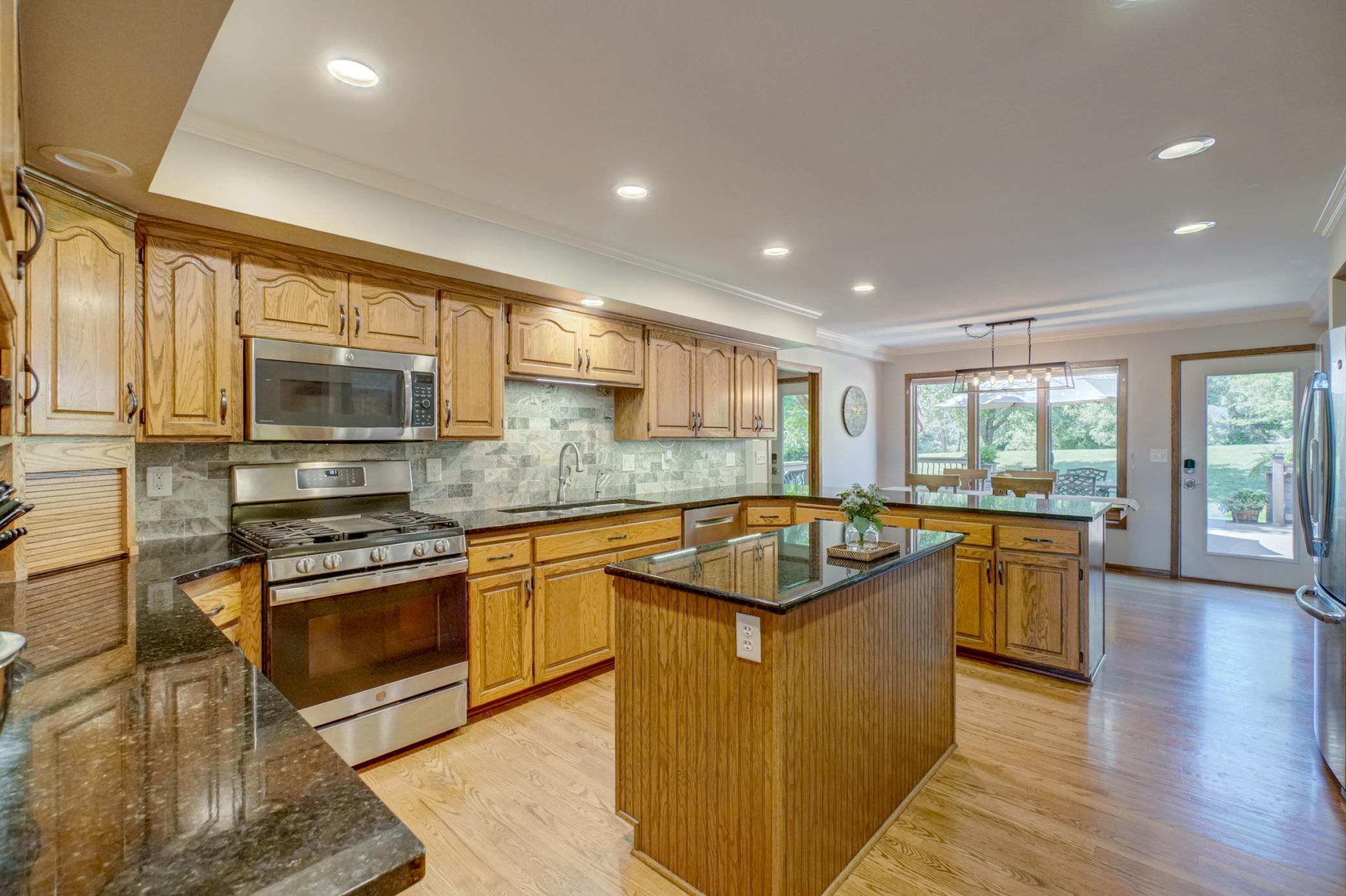 Prepare meals with ease in this updated kitchen featuring granite countertops, new stainless-steel appliances, reverse osmosis water filtration, and generous walk-in pantry storage