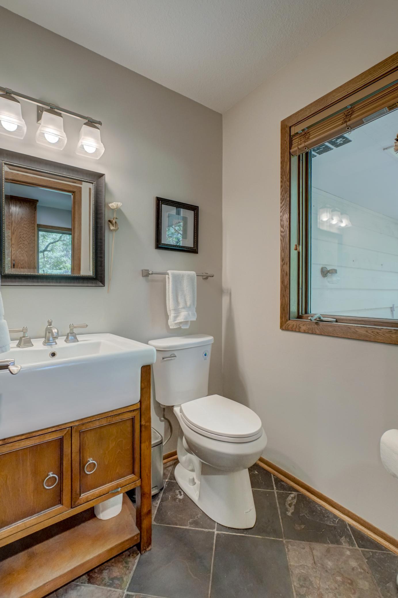 Two conveniently located half baths—including one adjacent to the laundry room with direct backyard access—add everyday functionality
