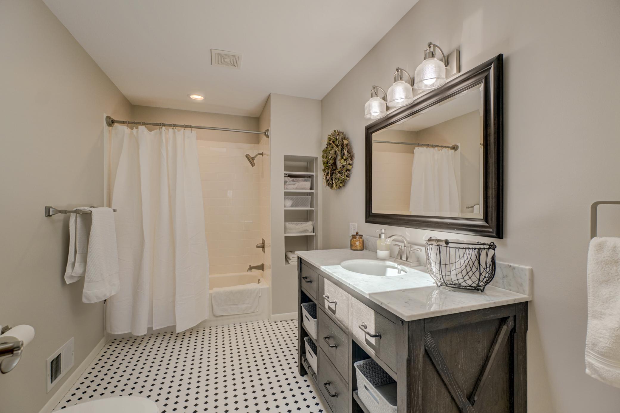 This upper-level bedroom is complemented by a beautifully remodeled private full bath