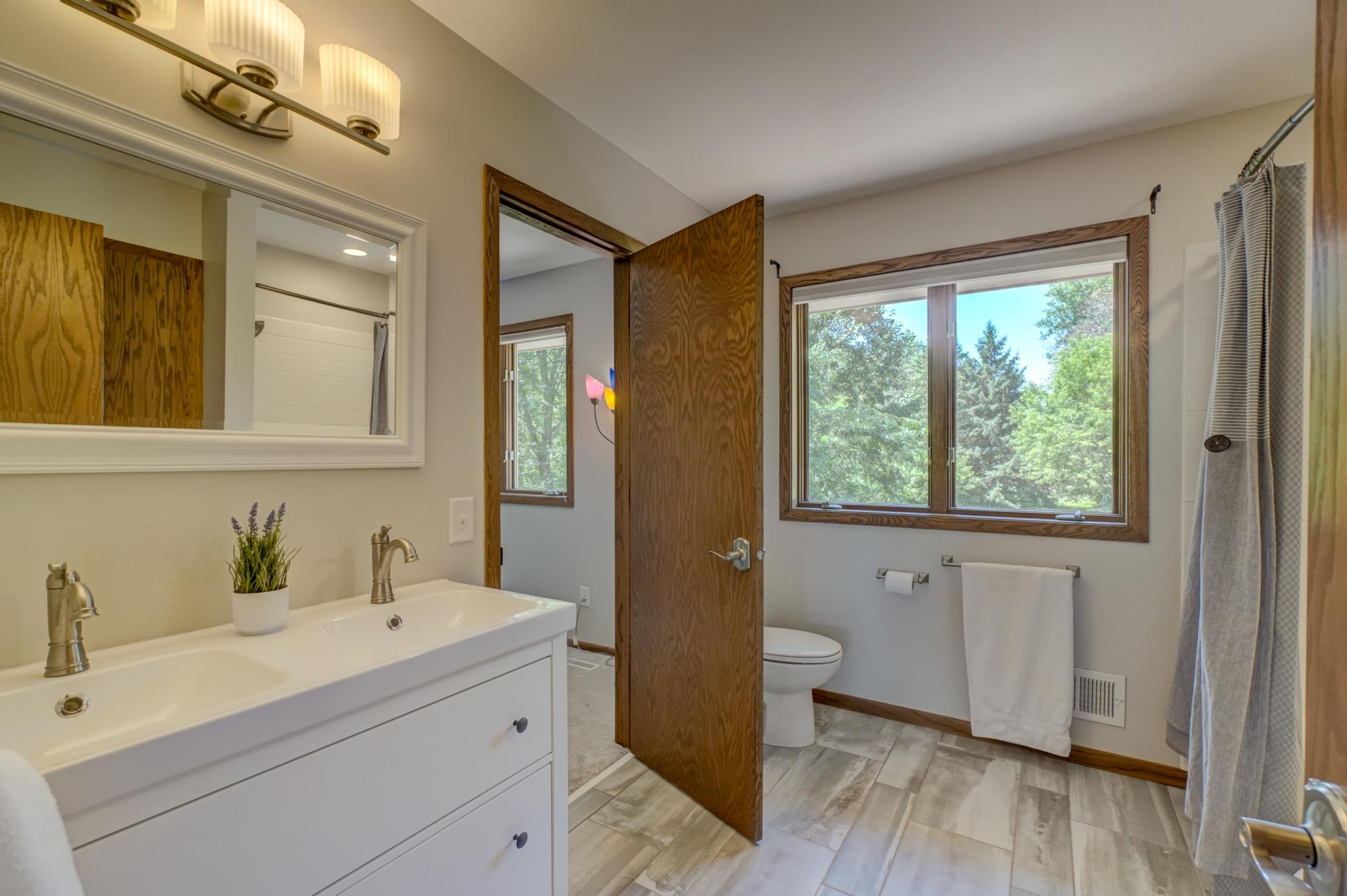 Beautifully updated walk-through full bathroom access enhances the functionality of this third upper-level bedroom