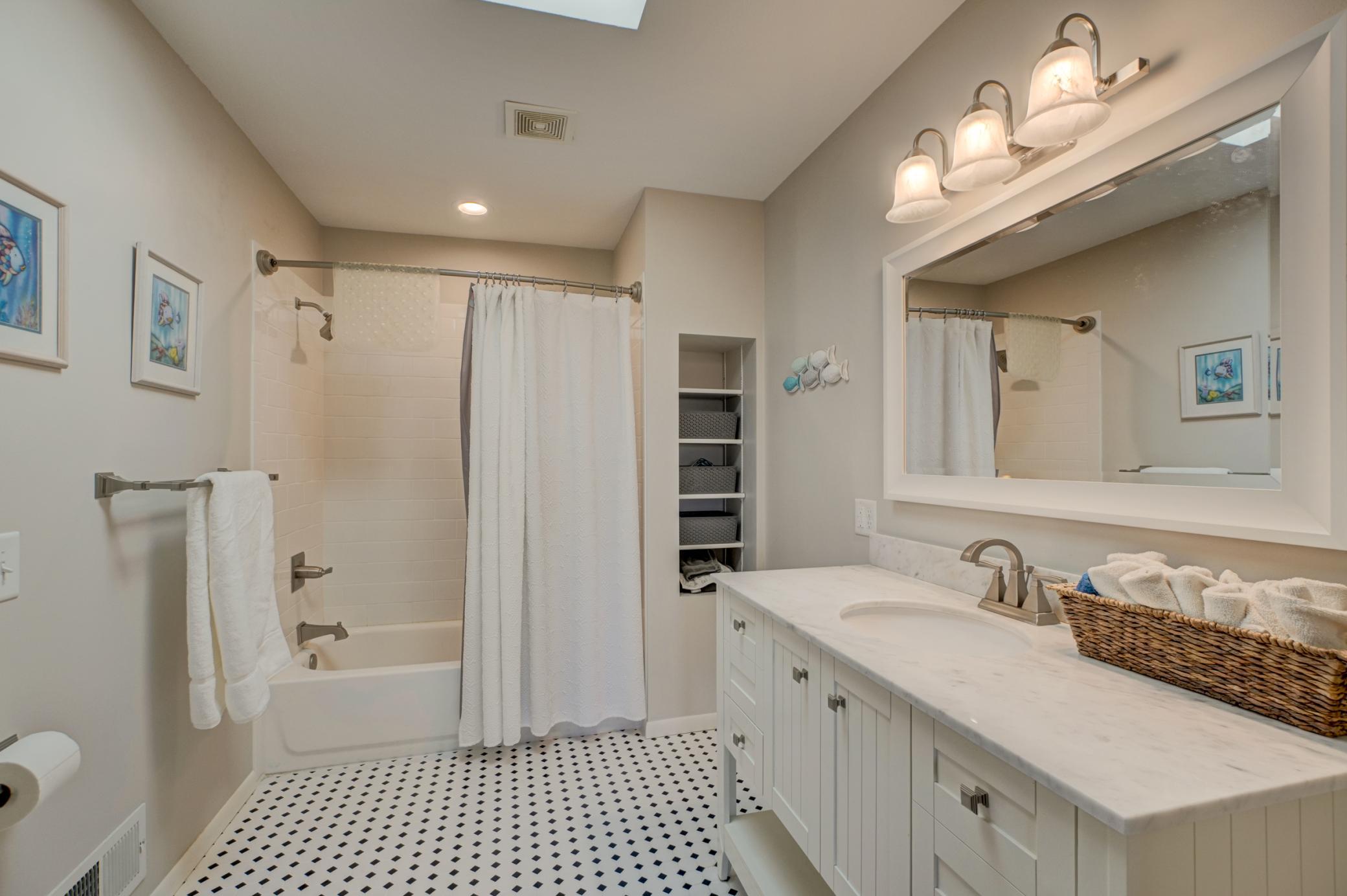 The newly updated private full bath offers both style and convenience for this upper-level bedroom