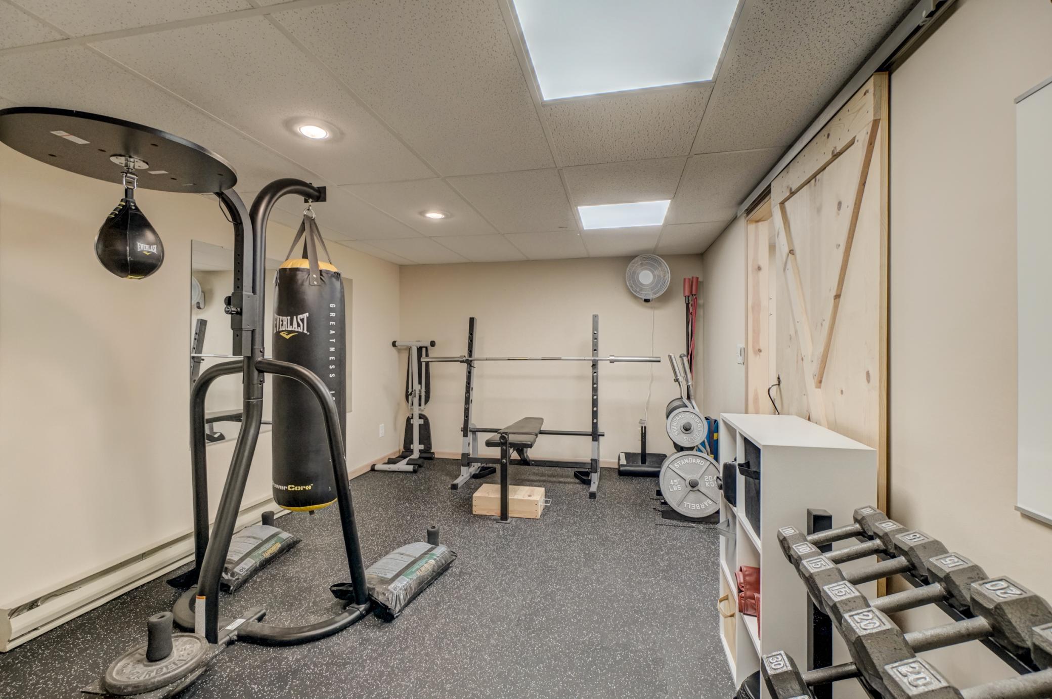 Stay active in the custom home gym featuring a convenient beverage bar