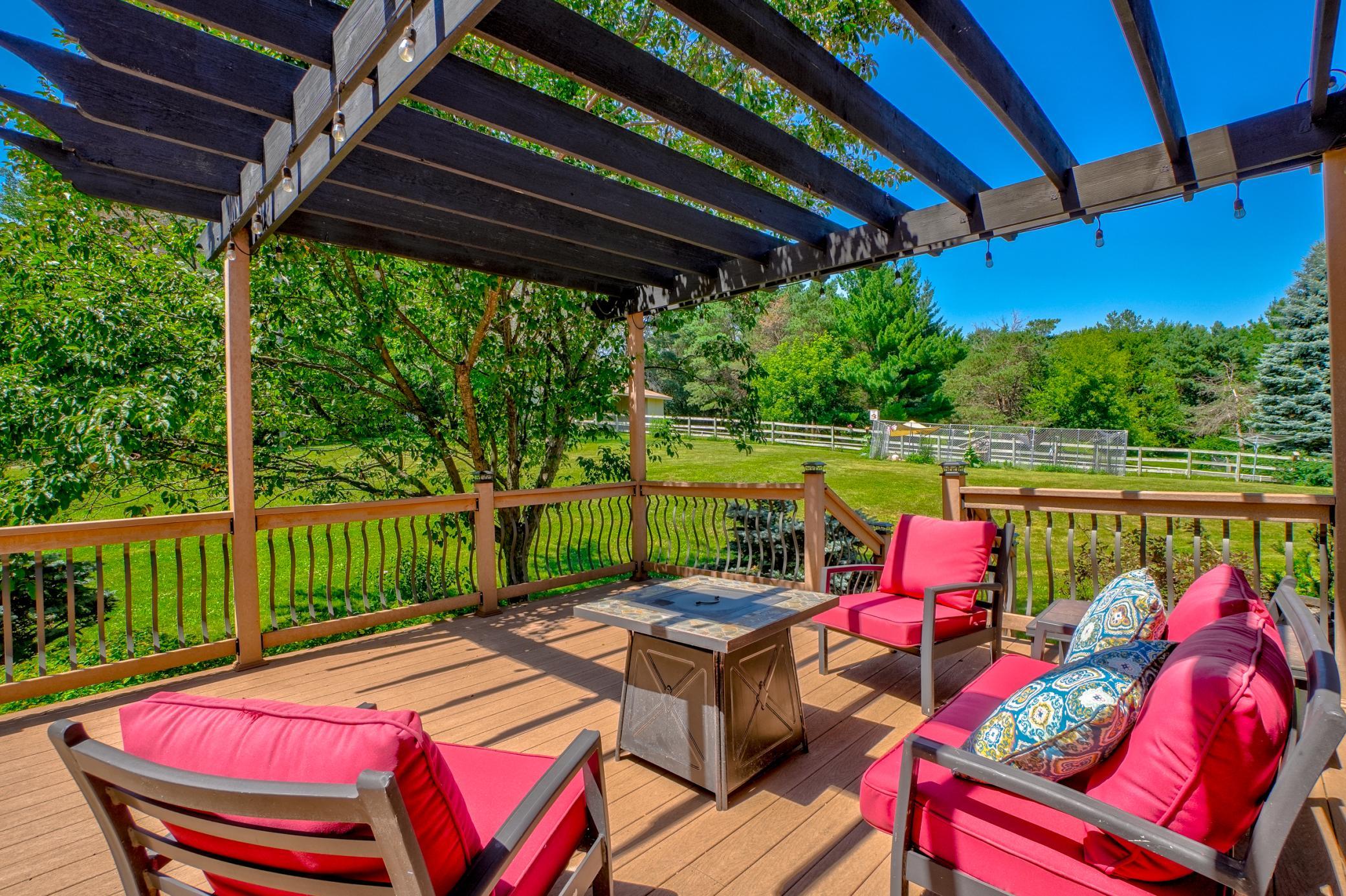 Relax under the pergola that overlooks the sprawling backyard perfect for year-round enjoyment