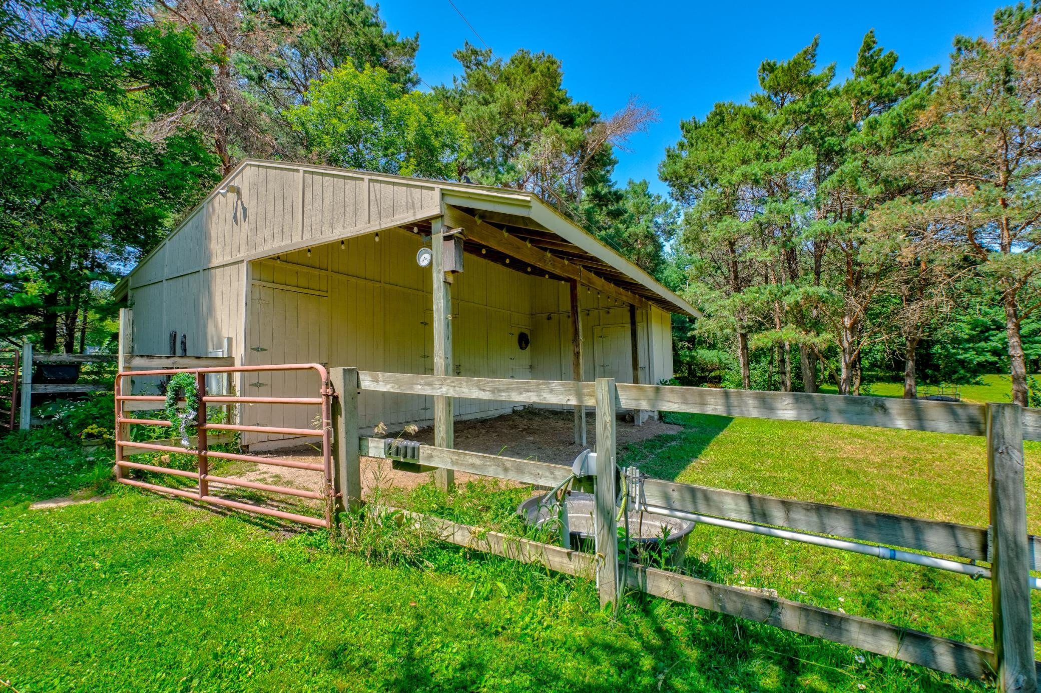 Equestrian enthusiasts will appreciate the impressive three-stall barn, complete with spacious 12x12 stalls, a dedicated tack room, and separate 200-amp electrical service