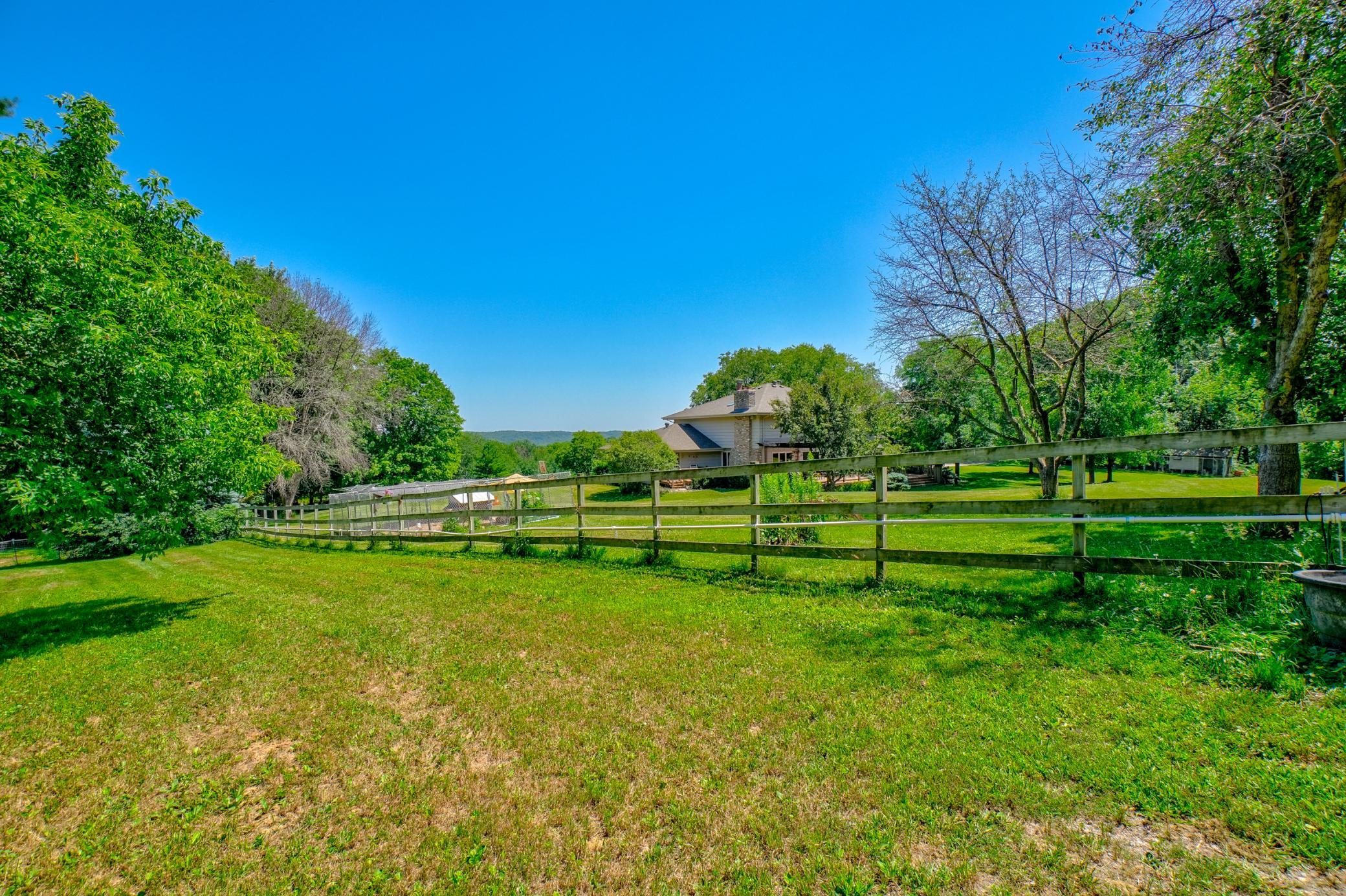 Fenced pasture with clover and grazing grasses, and a frost-free watering system conveniently located just steps from the back door