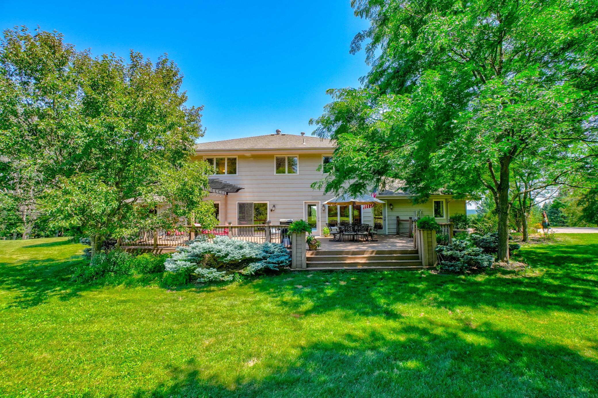 Surrounded by gorgeous landscaping, vibrant gardens, and lush greenery, this property is a private natural oasis