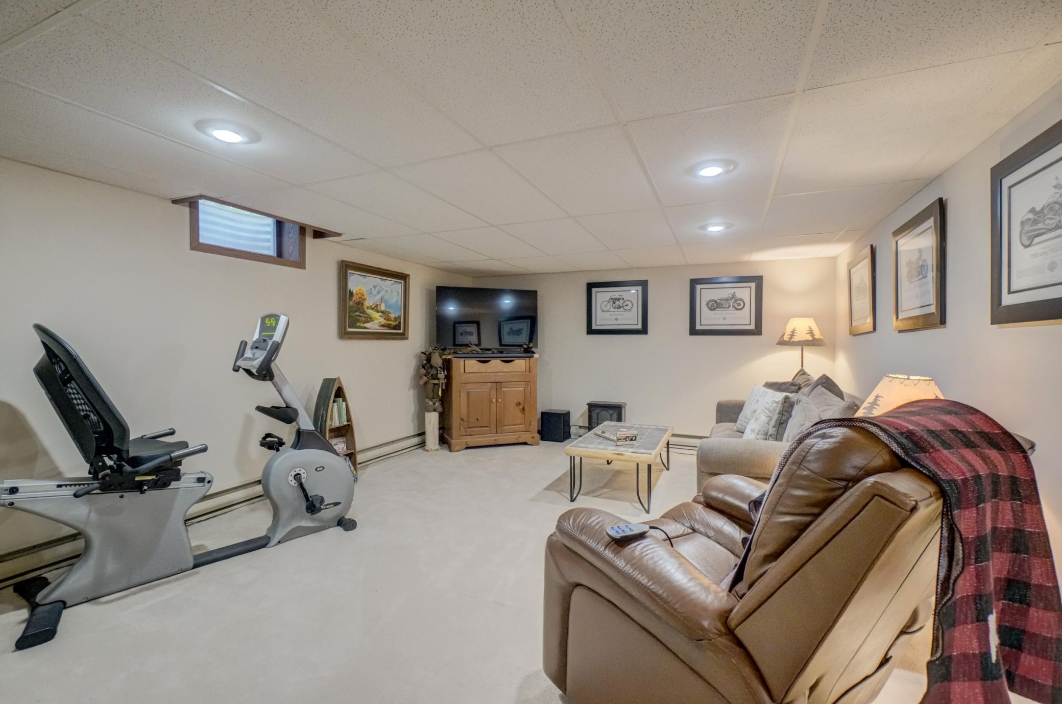 The finished lower level offers incredible versatility with a spacious family room perfect for gathering and entertaining