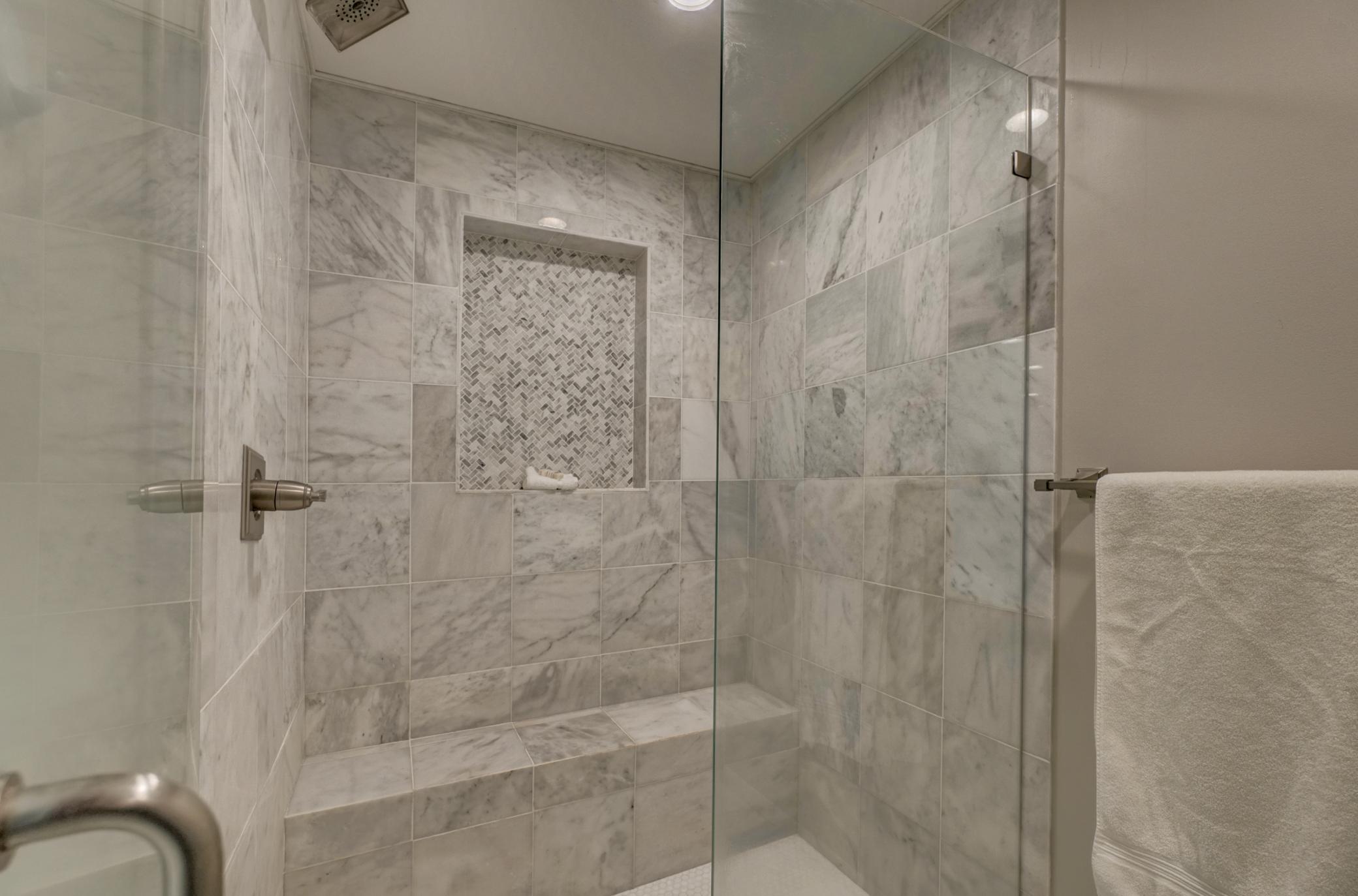 Experience everyday luxury with this stunning custom floor-to-ceiling tiled shower