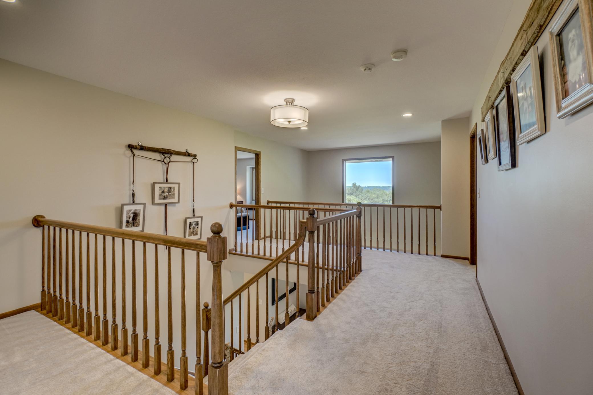 The combination of soaring ceilings and the open catwalk creates a bright, welcoming space with exceptional architectural appeal