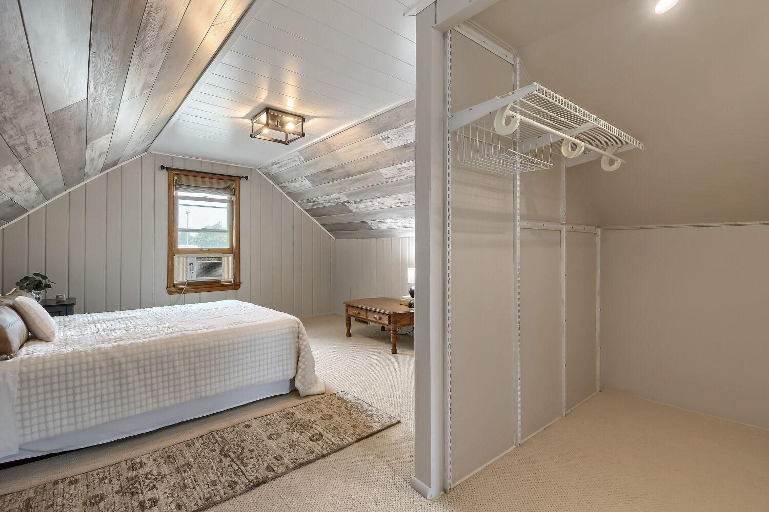The upper primary bedroom features new ceiling panels to brighten the space. And that closet!?