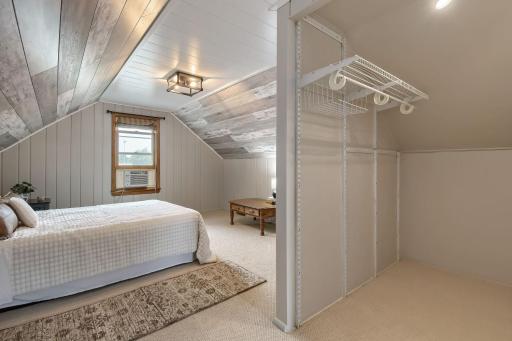 The upper primary bedroom features new ceiling panels to brighten the space. And that closet!?