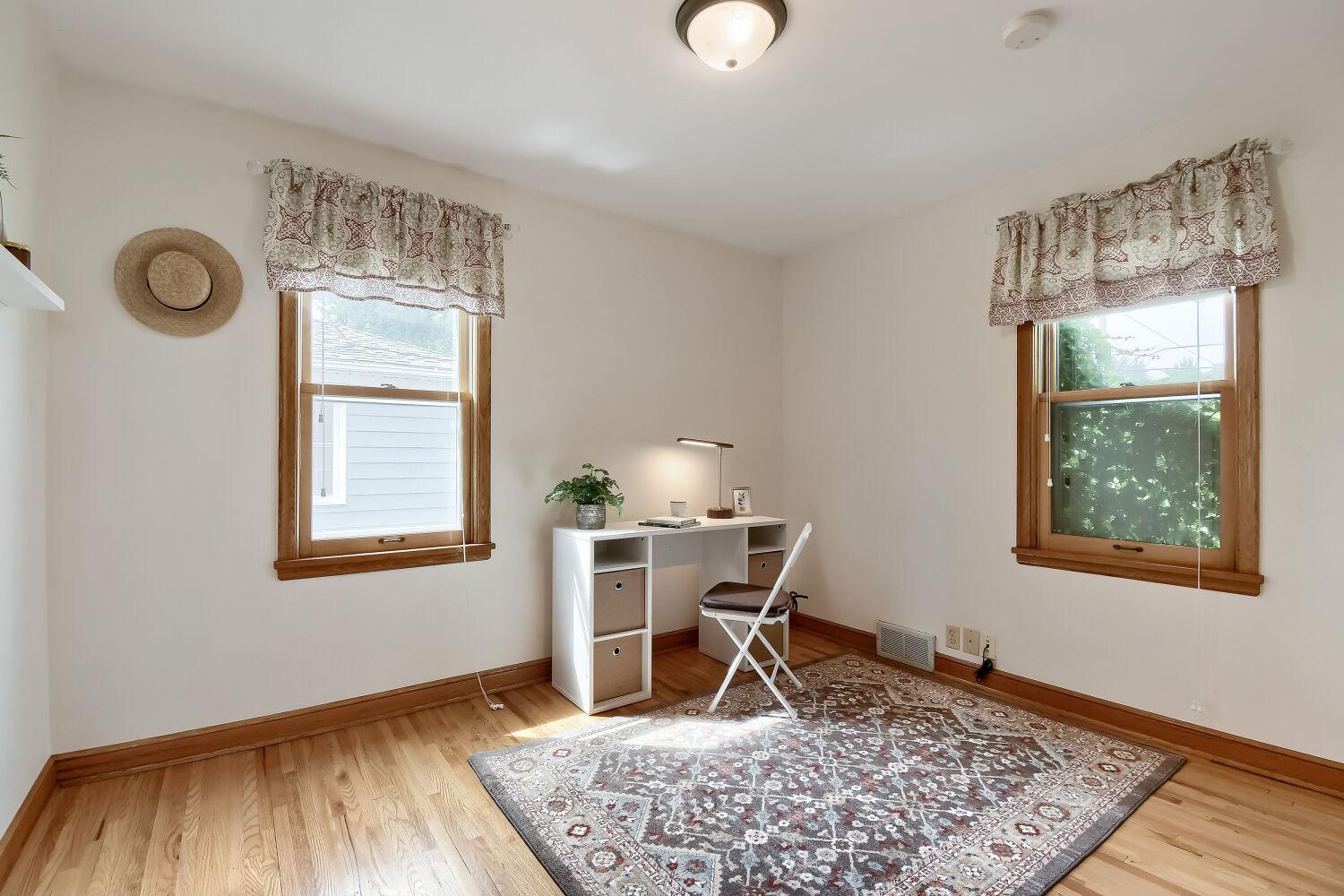Second bedroom on the main floor is equally sizeable. Look at the ivy peaking through! Such cottage vibes.