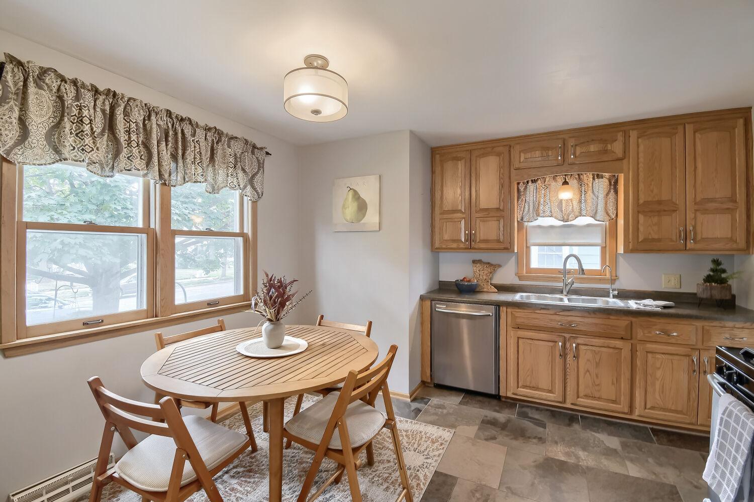 The eat-in-kitchen provides more east-facing window light and solid oak cabinets.