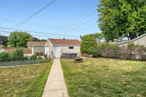 Fully fenced backyard is hot tub ready and features established gardens.