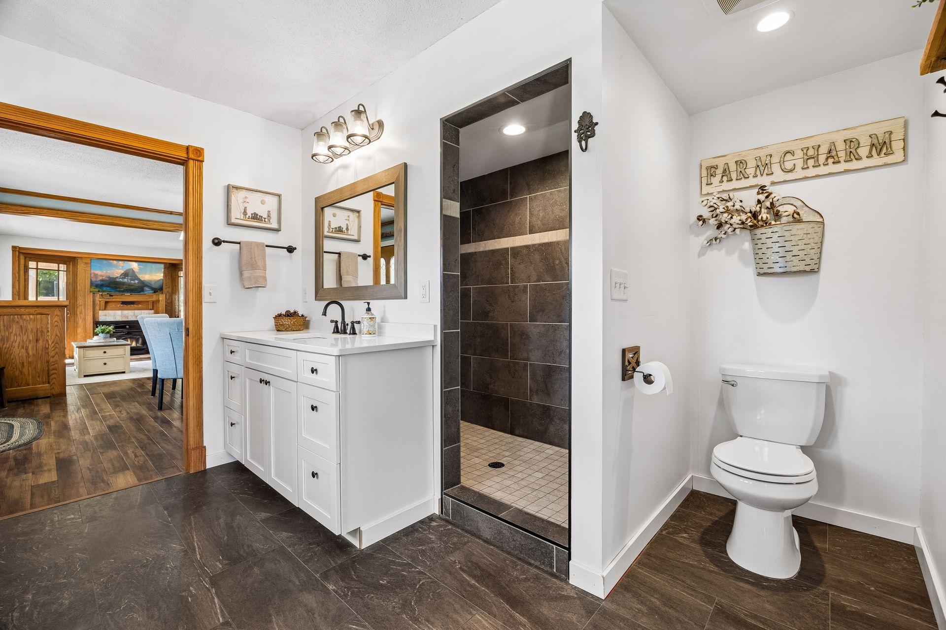 This gorgeous main level primary bathroom was added within the last few years.
