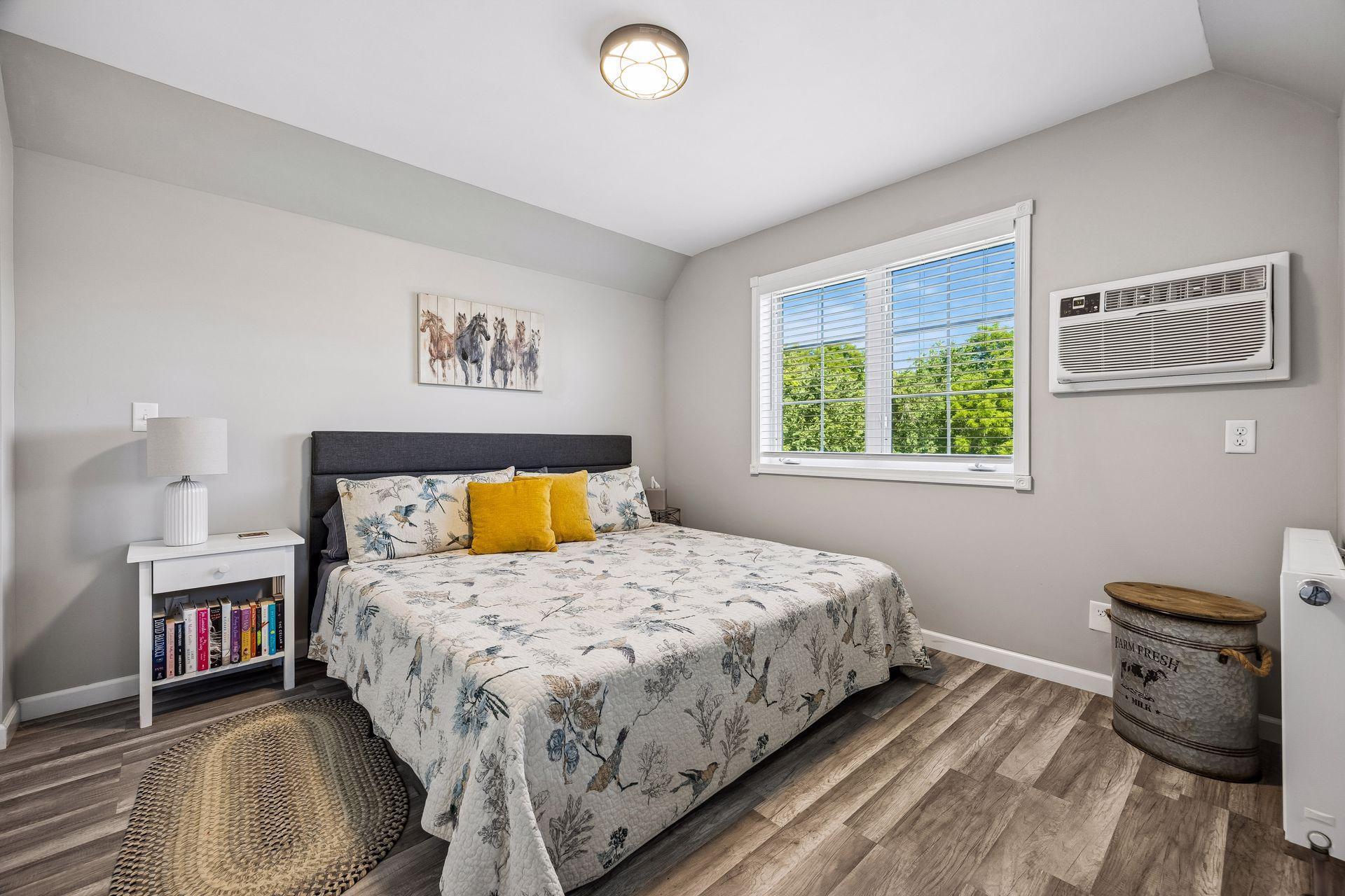 The bedroom in the guest suite easily fits a king-sized bed, and has a wall air conditioner